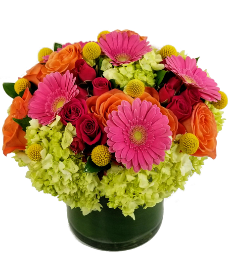 Orange roses, green hydrangea, pink spray roses and more in a leaf linfed vase.